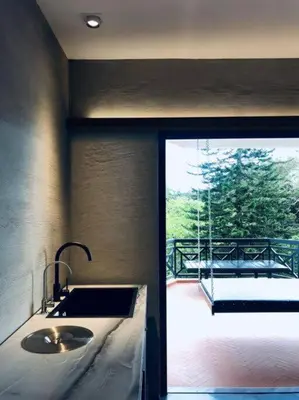 a bathroom with a sink and a view of a balcony at 80 Colonie Fraser's Hill 4pax in Bukit Fraser
