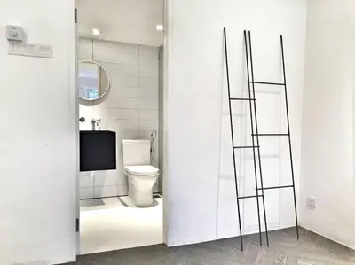a bathroom with a toilet and a television in it at 80 Colonie Fraser's Hill 16 Pax in Bukit Fraser