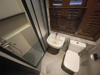 a small bathroom with a toilet and a sink at The Magazine Boutique Hotel in George Town
