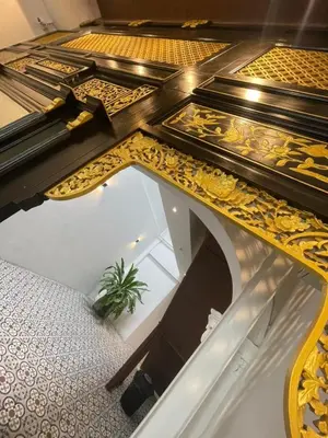 a gold and white table with a plant underneath it at The Magazine Boutique Hotel in George Town