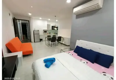 a bedroom with a bed and an orange chair and a kitchen at City Town 2-6 Pax Beautiful View Cozy Condo, Jelutong, Georgetown, Centre Heart Of Penang Island, near Highway Komtar Gurney in George Town