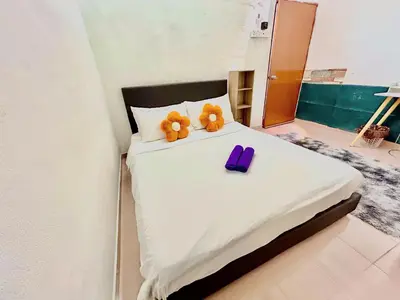 a bed with two teddy bears sitting on top of it at Cozy 255 Entire 3 Bedroom House At Alma Bukit Mertajam in Bukit Mertajam