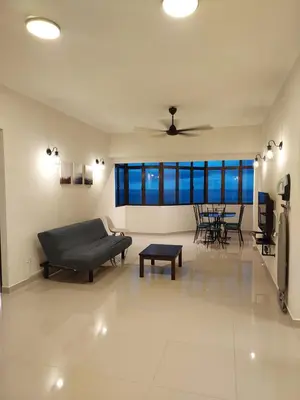 a living room with a couch and a table at Batu Ferringhi Luxury Seaview Suite - 3Br in Batu Ferringhi