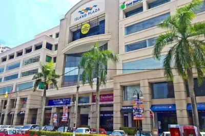 a large building with palm trees in front of it at YOU & ME 118 SWEET HOUSE in Tanjong Tokong