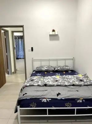 a bed with a blue comforter in a bedroom at Azzalea Homes 6 @ Taman Golden Hills Cameron Highlands in Tanah Rata