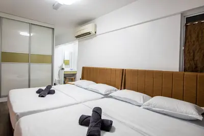 a bedroom with two beds with towels on them at 2Bedrooms Maritime Luxury Seaview Suite 2-10pax in Jelutong