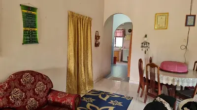 a living room with a table and a dining room at LOST WORLD OF TAMBUN HOMESTAY in Kampong Batu Lapan