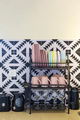 a shelf with plates and wine glasses on a wall at EE's Surfer's House - Seaview, 3 min walk to beach in Batu Ferringhi