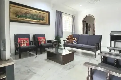 a living room with a blue couch and chairs at 5 Bedroom 2 Bathrooms End-lot House, 3 parkings - Ipoh, Tambun in Ipoh
