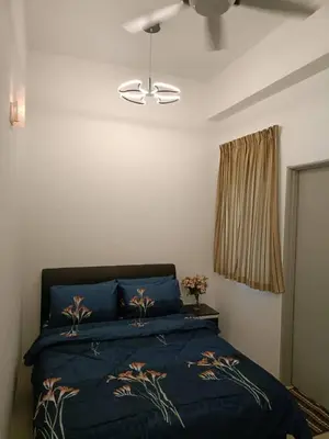 a bedroom with a blue bed and a ceiling fan at Alyaleesya homestay muslim night market in Brinchang