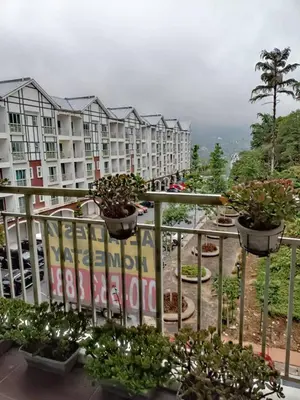 a balcony of a apartment complex with potted plants at Alyaleesya homestay muslim night market in Brinchang