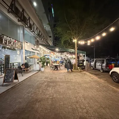 a parking lot with a table and chairs at night at 6 PAX 1 BEDROOM SOHO near SPICE ARENA PANTAI SPECIALIST AIRPORT in Bayan Lepas