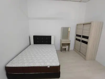 a bedroom with a bed and a dresser at GP Hostel Penang in George Town
