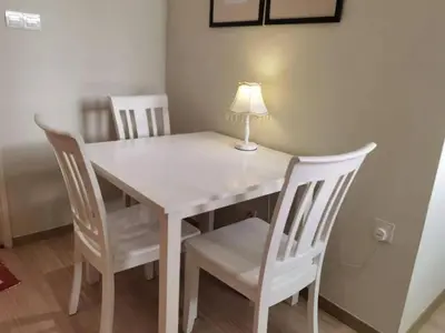 a white table and chairs with a lamp on it at The Regency Luxury Suite -Gurney Strait Quay in Tanjong Tokong