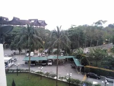 a parking lot with cars parked in a parking lot at Batu Feringgi Sri Sayang Apartment in Batu Ferringhi