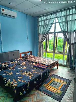 a bedroom with a bed in a room with a window at SR Kampar Homestay, Bandar Baru Kampar in Kampar