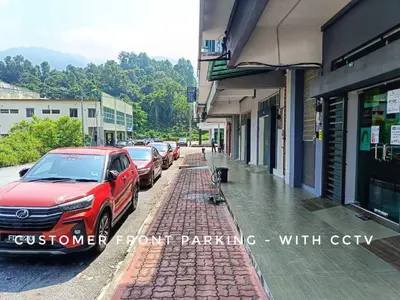a red car parked on the side of a street at SR Kampar Homestay, Bandar Baru Kampar in Kampar