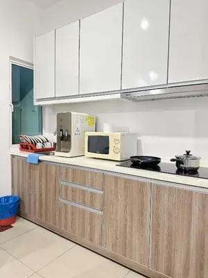 a kitchen with white cabinets and a microwave at The Majestic Ipoh Town by 178homestay in Ipoh