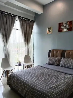a bedroom with a bed and a large window at Armada Sweet Homestay in Gua Musang