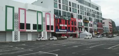 a city street with cars parked in front of buildings at Armada Sweet Homestay in Gua Musang