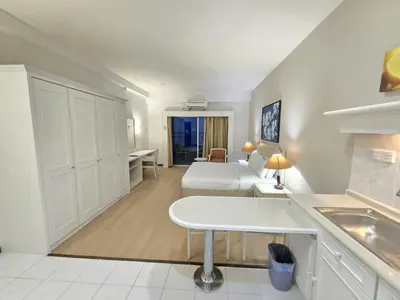a large white room with a bed and a kitchen at Rainbow paradise at Tanjung Bungah in Tanjung Bungah