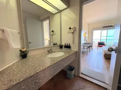 a bathroom with a sink and a large mirror at Rainbow paradise at Tanjung Bungah in Tanjung Bungah