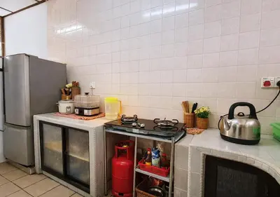 a kitchen with a stove and a refrigerator at Advent Villa, just 80 meters to Penang Adventist Hospital in George Town