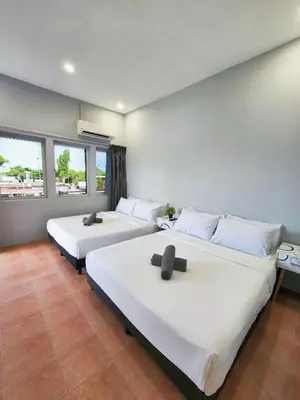 a bedroom with two beds and a large window at Gurney Coast Guest House by Sky Hive in George Town