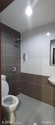 a bathroom with a toilet and a sink at The Great Hotel in Ipoh