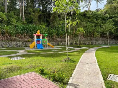 a playground in a park with a childs play equipment at Cozystay @ The Quintet, Cameron in Tanah Rata