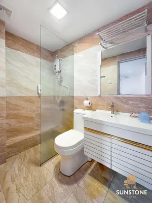 a bathroom with a toilet and a sink and a shower at Sunstone Hotel in George Town