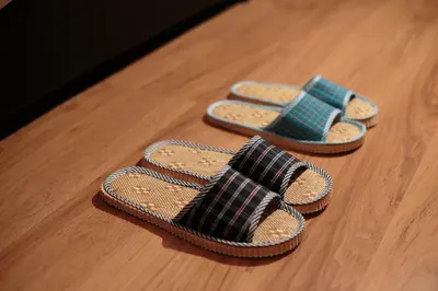 a pair of sandals sitting on a wooden floor at Sunstone Hotel in George Town