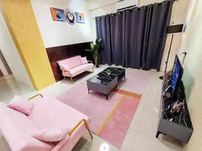 a living room with a couch and a flat screen tv at Pavilionvillie M1T583 by irainbow in Kampong Kepayang