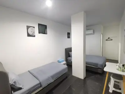 a room with a bed and a couch and a table at 184 GURNEY DRIVE PENANG in George Town
