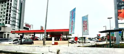 a gas station with cars parked in a parking lot at D'Serina Homestay-3 bedroom 6 bed & free parking in Sungai Petani