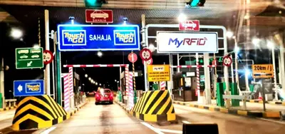 a car driving through a tunnel with lots of signs at D'Serina Homestay-3 bedroom 6 bed & free parking in Sungai Petani
