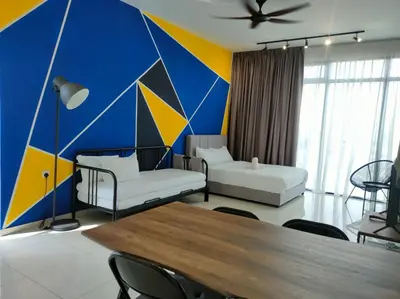 a living room with a blue and yellow wall at Beacon Executive Suites 2BR at Georgetown by WL in George Town