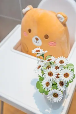 a teddy bear and a vase of flowers on a table at Ipoh Tambun Lost World Sunway Onsen Suites Luna 2R2B 8paxs in Ipoh