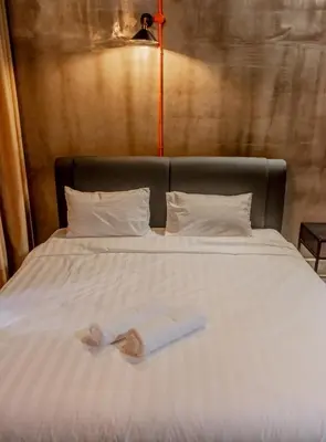 a bed with two towels sitting on top of it at PADI Sentral @ Sekinchan in Sekincan