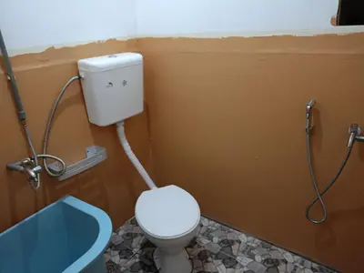 a bathroom with a toilet and a shower at Purple Pool Villa in Kampong Batu Dua Puloh Tiga