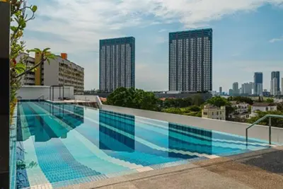 a large swimming pool on the roof of a building at Deluxe Seaview Suite King Bed by The Only Bnb in Tanjong Tokong