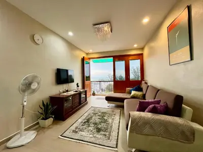 a living room with a couch and a tv at The Rockview Bayu Emas Penang Near Beach in Batu Ferringhi