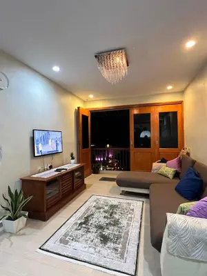 a living room with a couch and a tv at The Rockview Bayu Emas Penang Near Beach in Batu Ferringhi