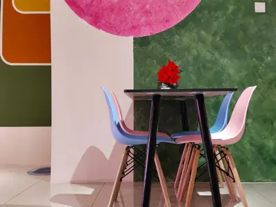a table with three chairs and a red flower in a vase at Pavilionvillie M1T570 by irainbow in Ipoh
