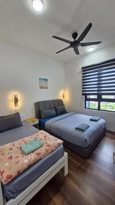 a bedroom with two beds and a ceiling fan at H&W Sunway Onsen Suite 4-7pax near Lost World of Tambun Ipoh in Ipoh