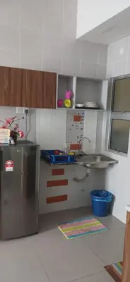 a kitchen with a stainless steel refrigerator and cabinets at 1 Bedroom Apartment @ Golden Hills Cameron Highlands Pasar Malam in Cameron Highlands