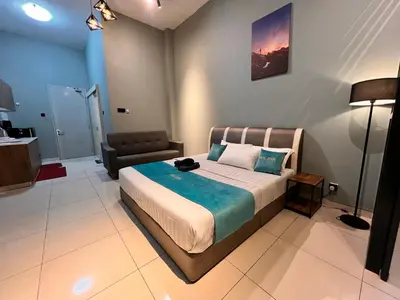 a bedroom with a bed and a living room at BLUE JADE STUDIOS in Tanah Rata