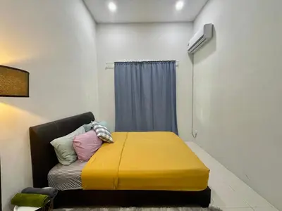 a small room with a bed with a yellow blanket at Comfort 36 Entire House At Alma Bukit Mertajam in Bukit Mertajam