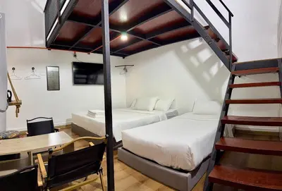 a room with two beds and a staircase at Ardour Lodge 
