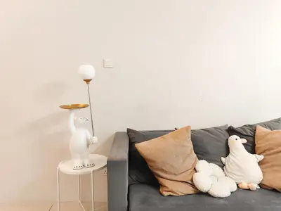 a gray couch with two stuffed animals on it at Ipoh Town Apartment 8pax by Cozy in Ipoh